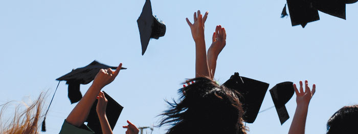 Mortar boards being thrown into air